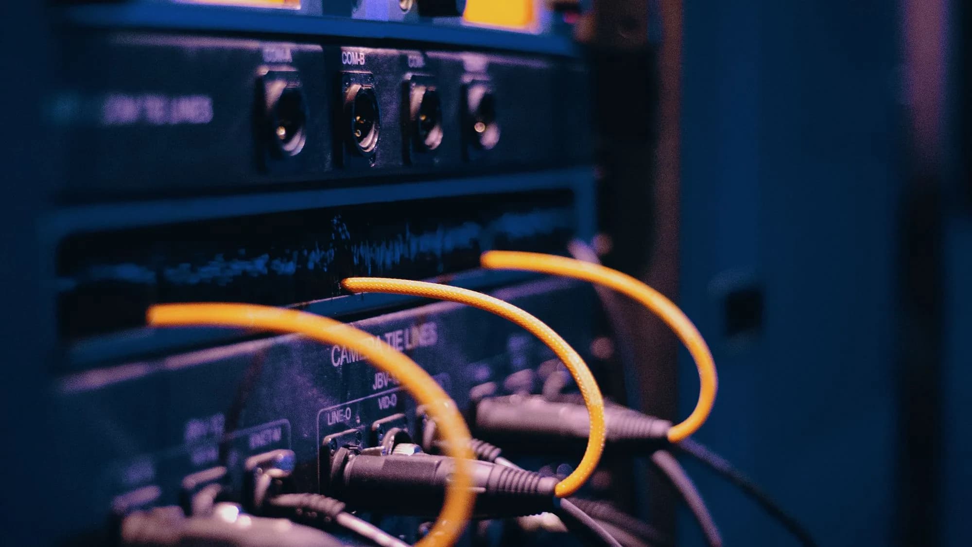 Network cables plugged into ports on a server rack
